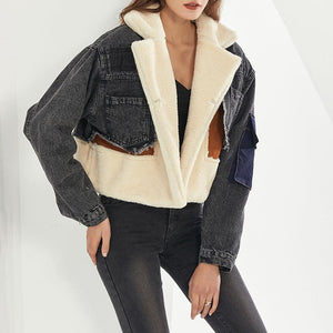 A woman wearing a casual denims jacket with sheep wool lining, in a color block style, featuring black and beige colors.
