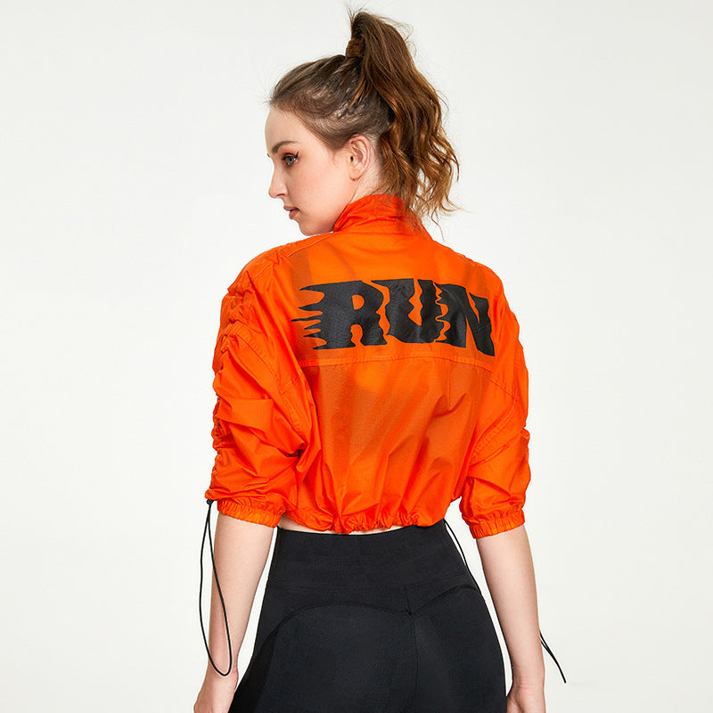 Person wearing an orange jacket with 'RUN' printed on the back against a white background