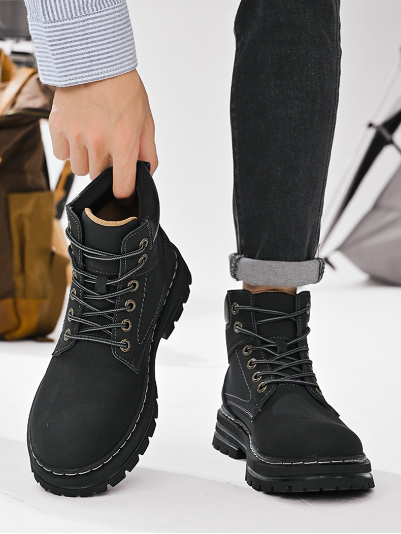 Person wearing black boots with a white background