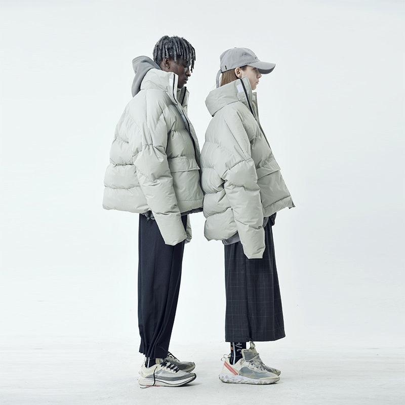 Two models wearing gray cotton coats with down filling, featuring a stand collar and loose mouth sleeves.