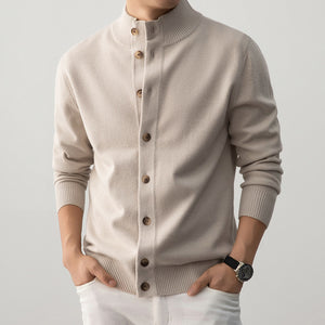 Beige cardigan worn by a person on a plain background