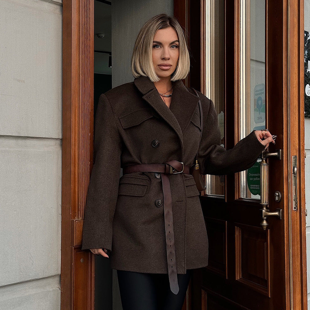 Woman in a brown coat standing in a doorway