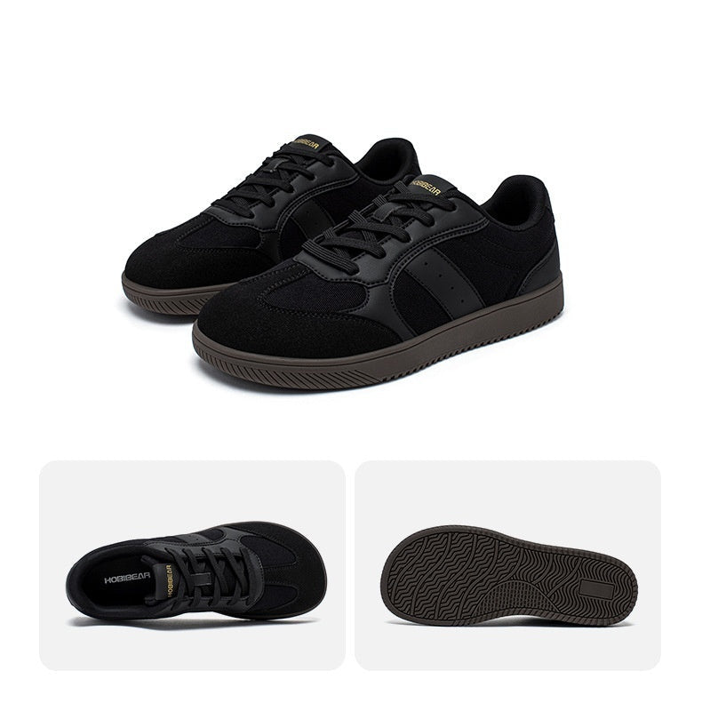 Black sneakers with a close-up of the sole on a white background