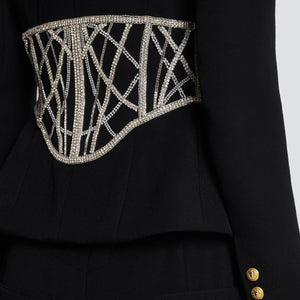 A high-end women's designer suit jacket in black with heavy beaded diamond detailing on the back.