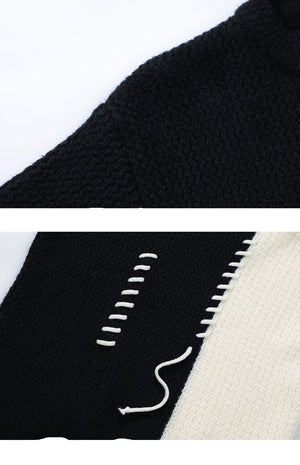 Close-up of a black and white fabric with intricate stitching details on a white background.