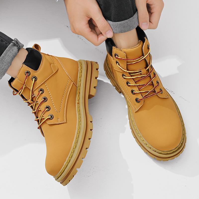 Yellow boots being worn on a white background