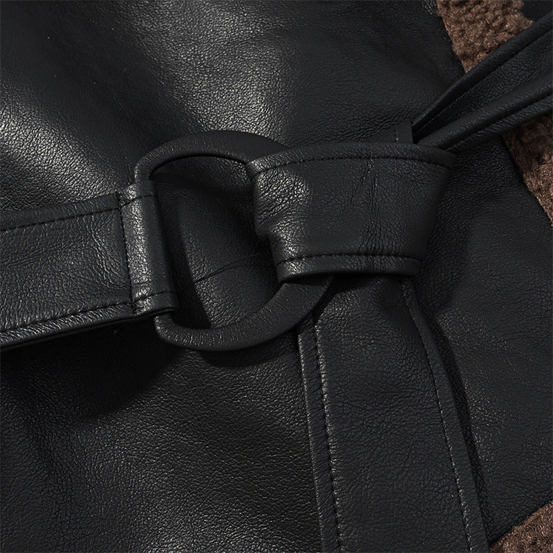 Close-up of a black leather belt with a buckle on a dark background