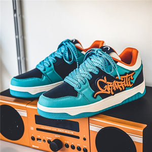 Blue and black sneakers with orange text on a boombox