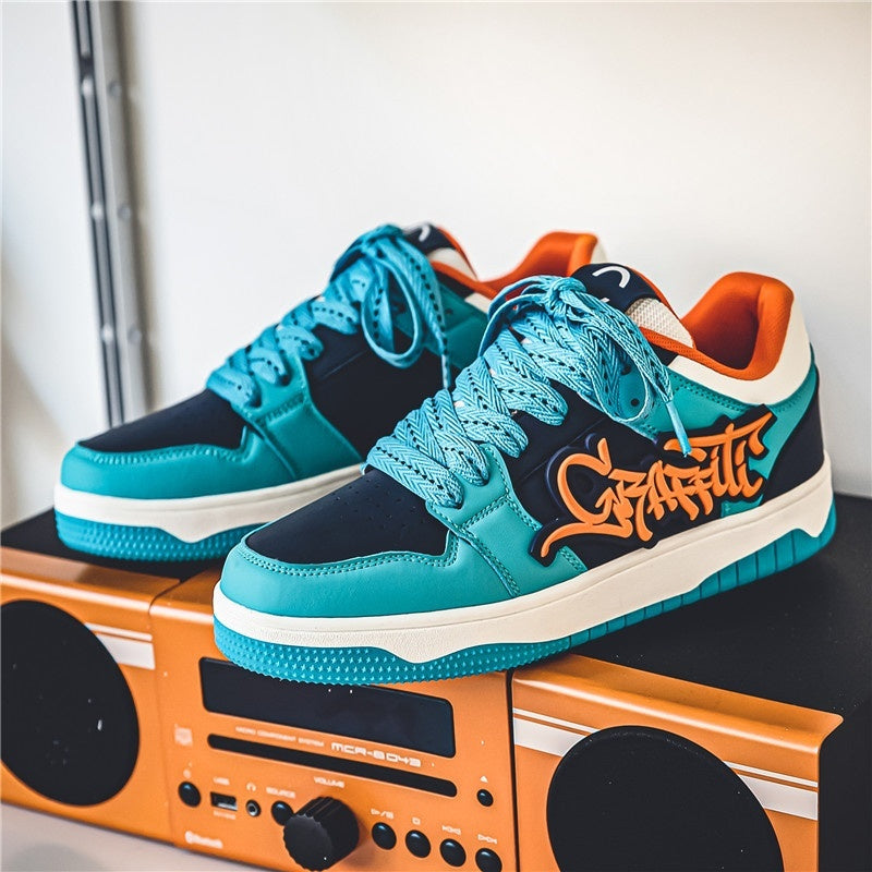 Blue and black sneakers with orange text on a boombox