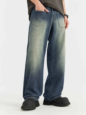 Person wearing blue jeans and black shoes on a white background