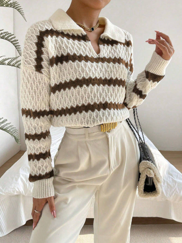 Person wearing a striped sweater and white pants in an indoor setting