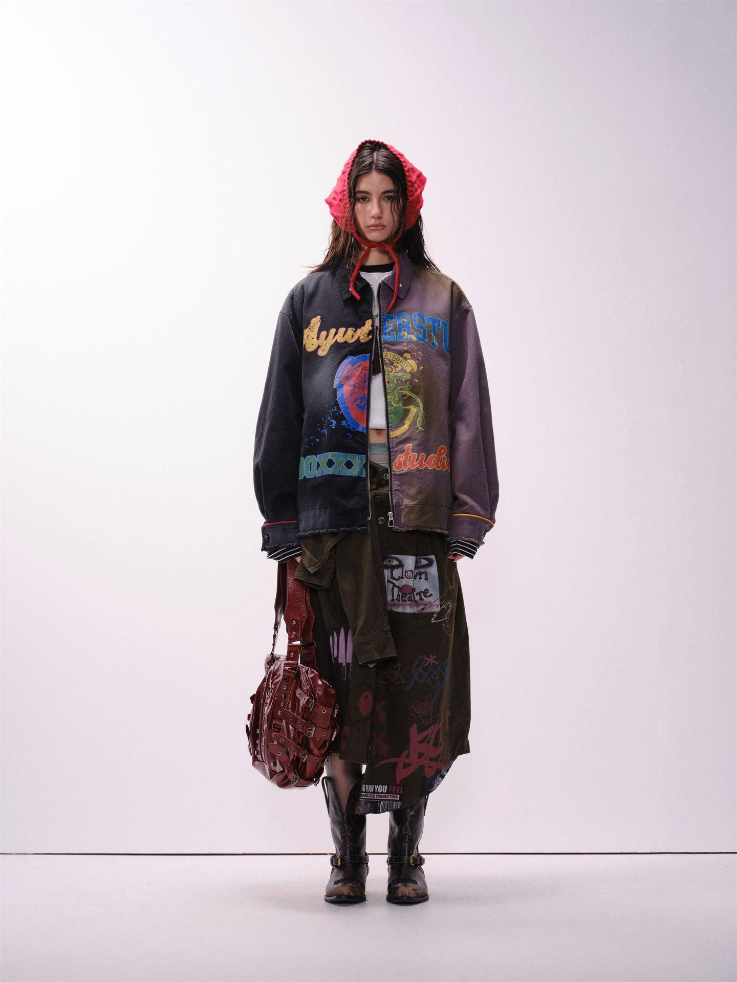 A person wearing a unisex, loose fit jacket with multicolored urban graffiti designs.
