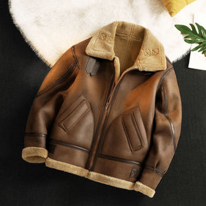 Brown leather jacket with beige fur lining on a dark surface