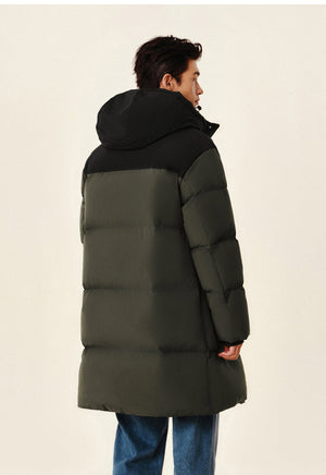 Man wearing a green and black puffer coat on a beige background