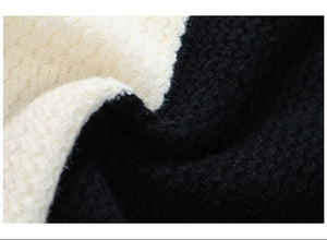 Close-up of textured fabric with black, white, and beige colors.