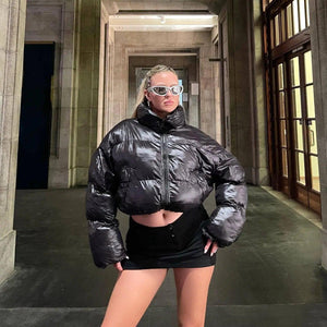 A person wearing a black cotton jacket with a stand collar, styled in a punk-inspired manner.