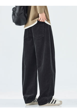 Person wearing black wide-leg pants with a plain background