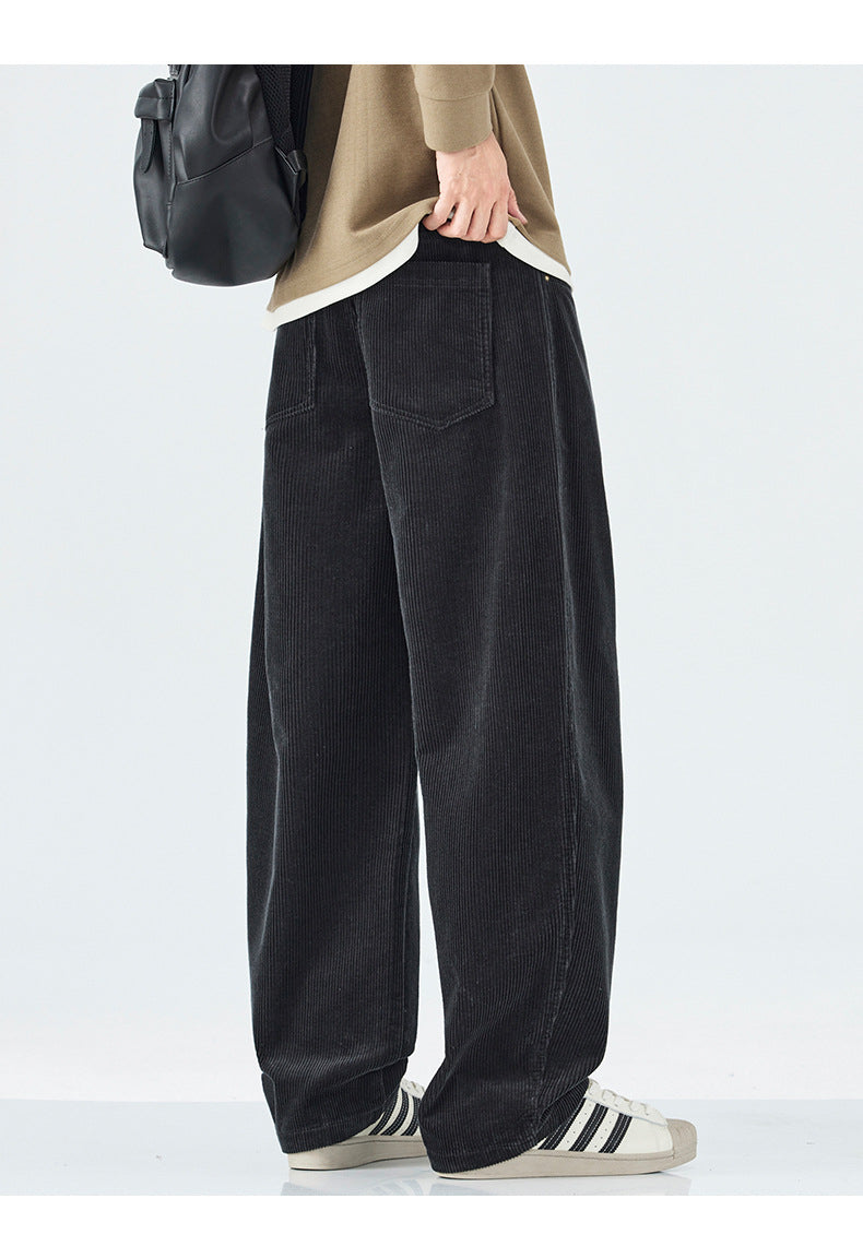 Person wearing black wide-leg pants with a plain background