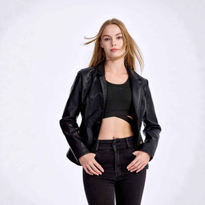 Woman wearing a black leather jacket, black top, and black pants on a white background