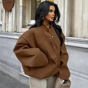 A person wearing a brown vintage woolen stand collar coat with button closures and loose fit.