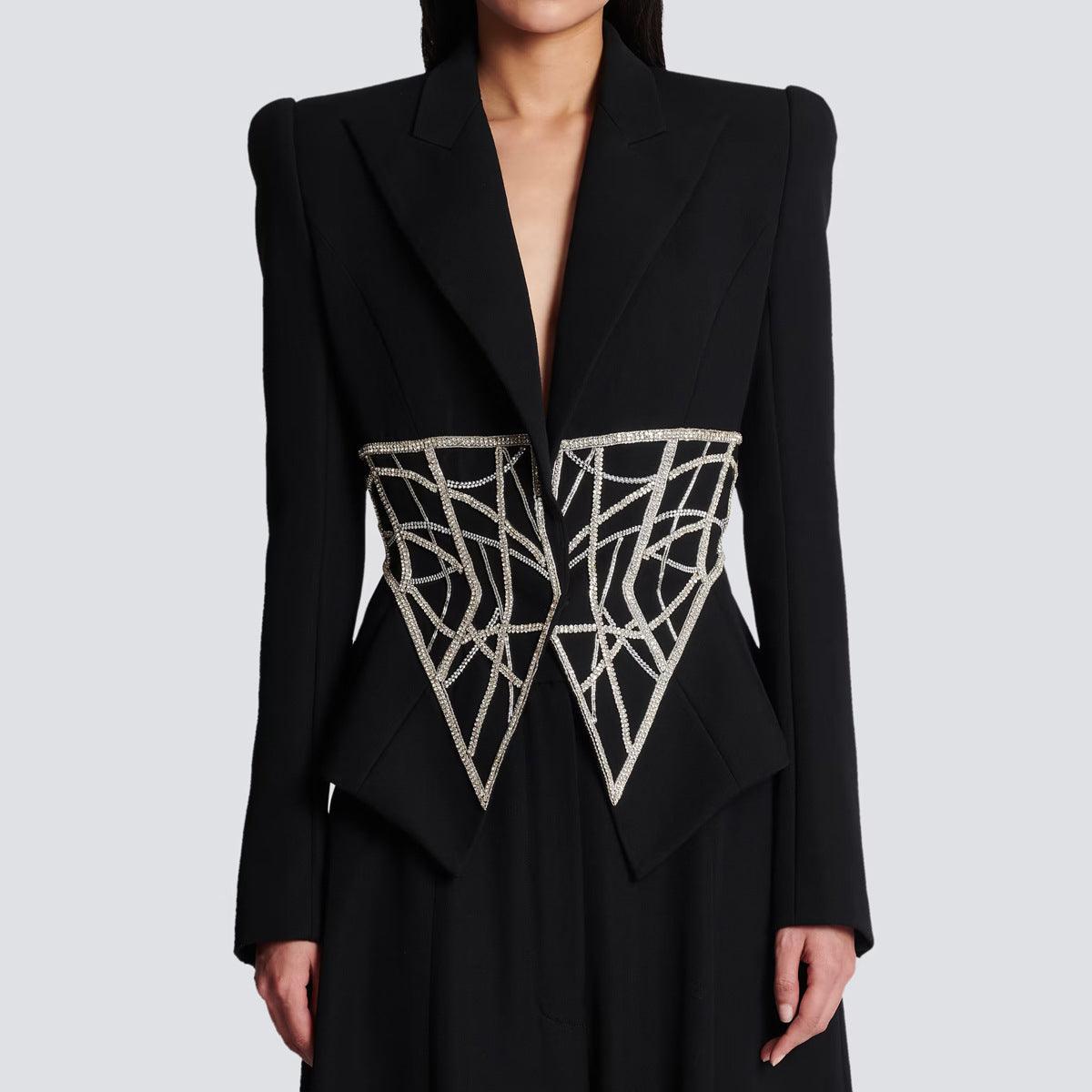 A high-end women's designer suit jacket in black with heavy beaded diamond detailing on the front.