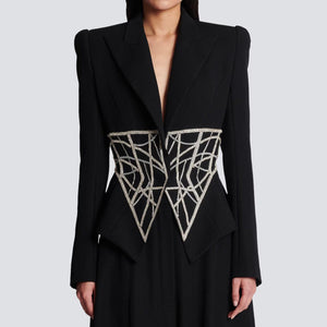 A high-end women's designer suit jacket in black with heavy beaded diamond detailing on the front.