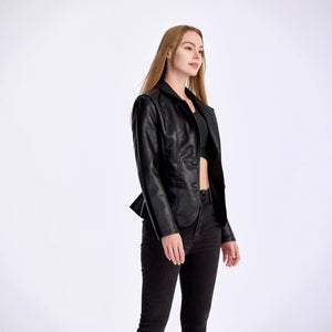 Woman wearing a black leather jacket and pants on a white background