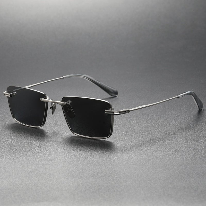 Polarized Sunglasses - UV - Proof Titanium - MRC STOREAccessoriesMy StoreA pair of women's polarized sunglasses with a black frame and grey lenses, displayed on a dark platform with a reflective surface.MRC STORECJCF201152101AZGun Frame Black And Gray