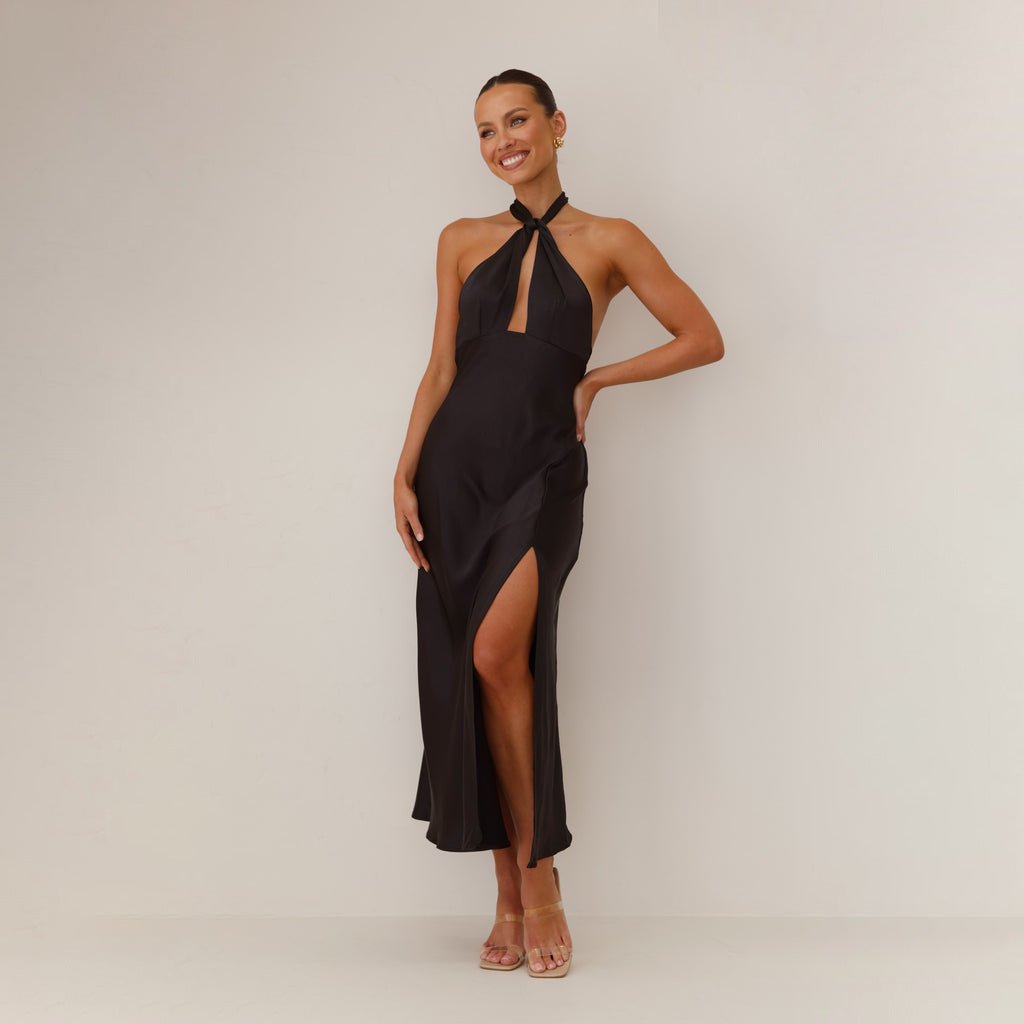 Sleeveless Dress - Backless Halter - MRC STOREDressMy StoreA woman models a sleeveless, backless halter dress in black, showcasing the dress's high waist and long skirt.MRC STORECJLY233585107GTBlackL