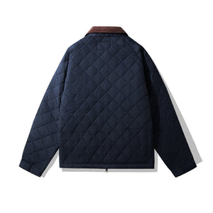 Navy quilted jacket with brown collar on a white background