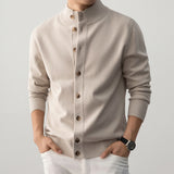 Beige cardigan worn by a person on a plain background