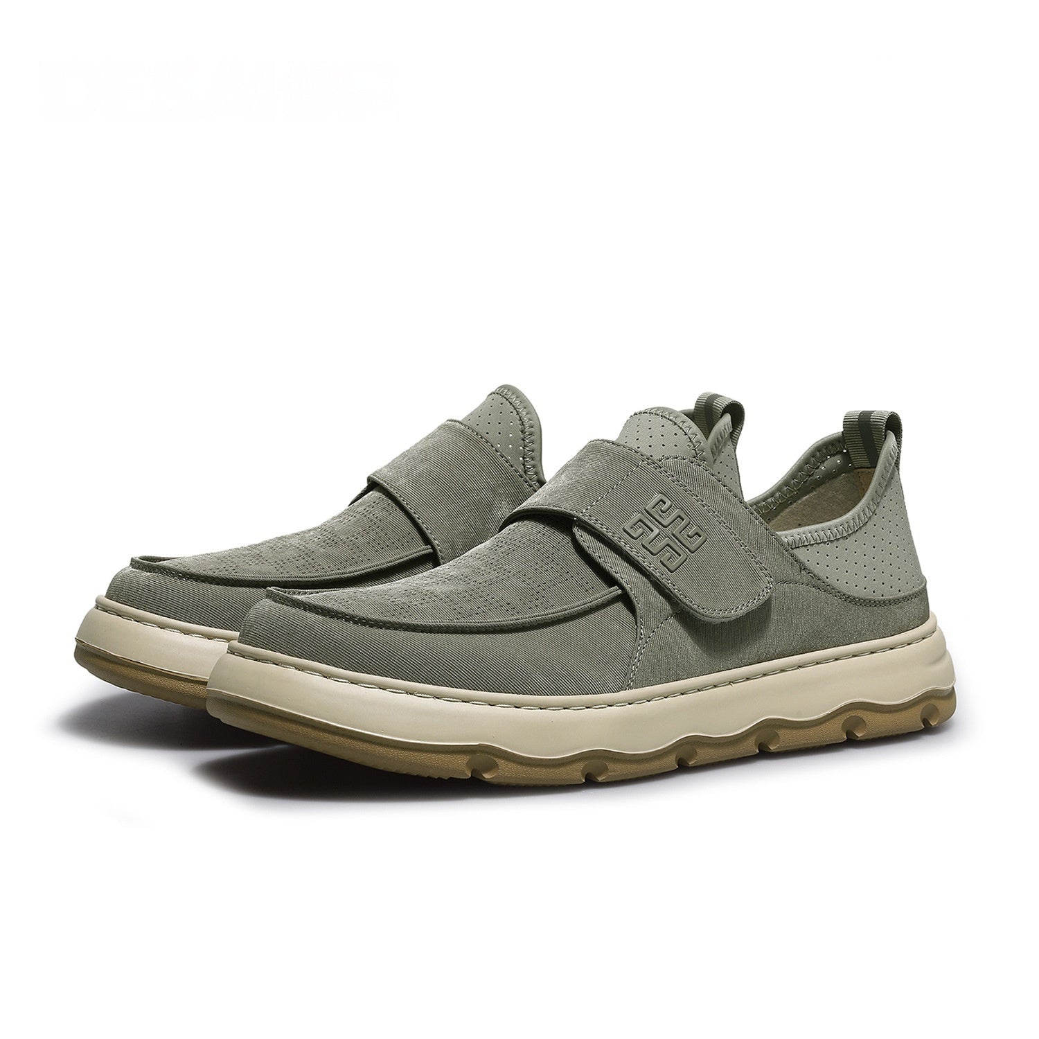 Pair of gray slip-on shoes with velcro straps on a white background