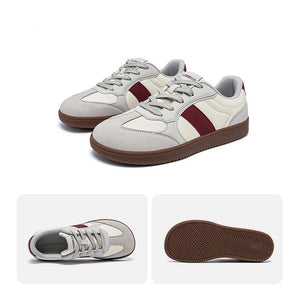 White and burgundy sneakers with a close-up of the sole on a white background