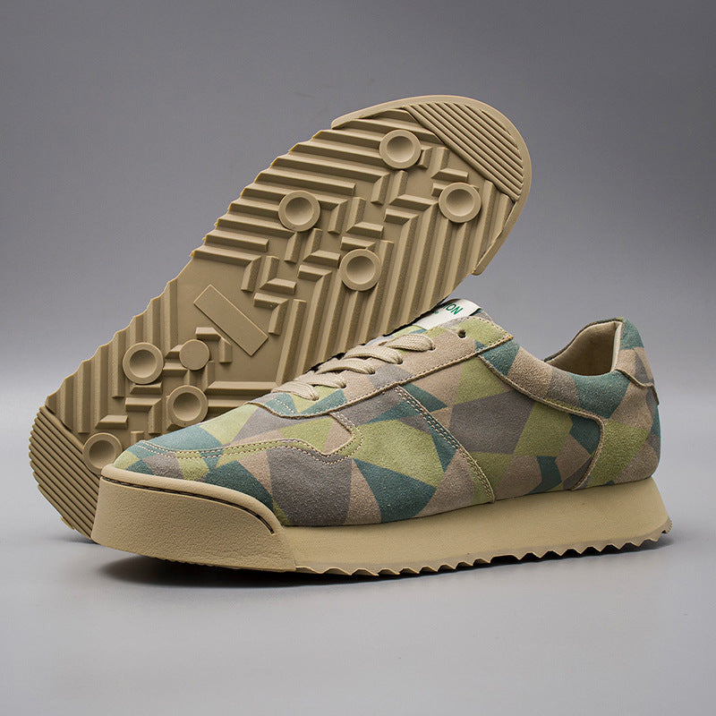 Camouflage sneaker with beige sole on a gray background