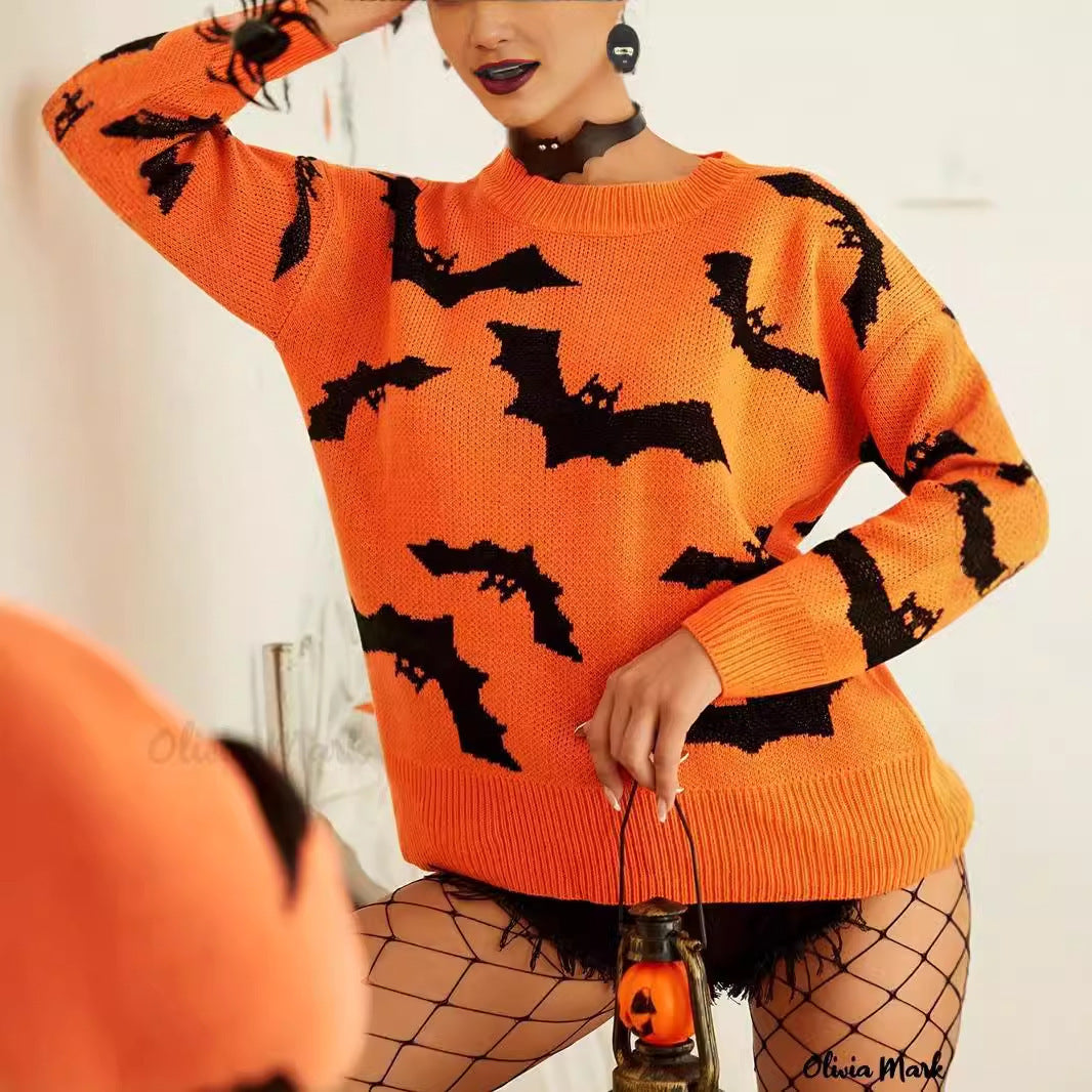 Person wearing an orange sweater with black bat patterns, holding a small lantern.