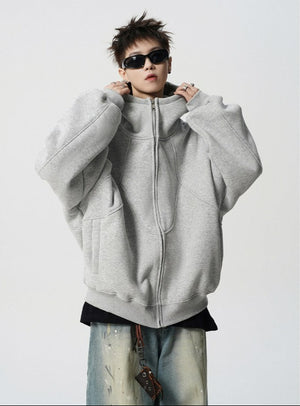 Person wearing a gray hoodie with sunglasses on a white background