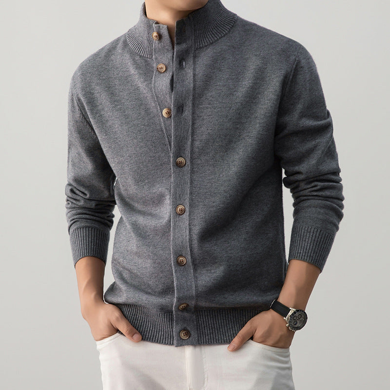 Gray cardigan with brown buttons worn by a person on a light gray background