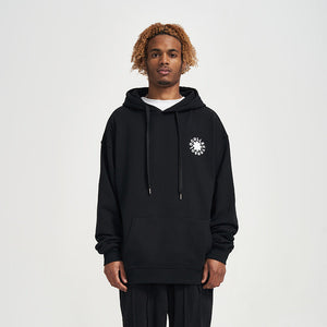 Person wearing a black hoodie with a white logo on a light gray background