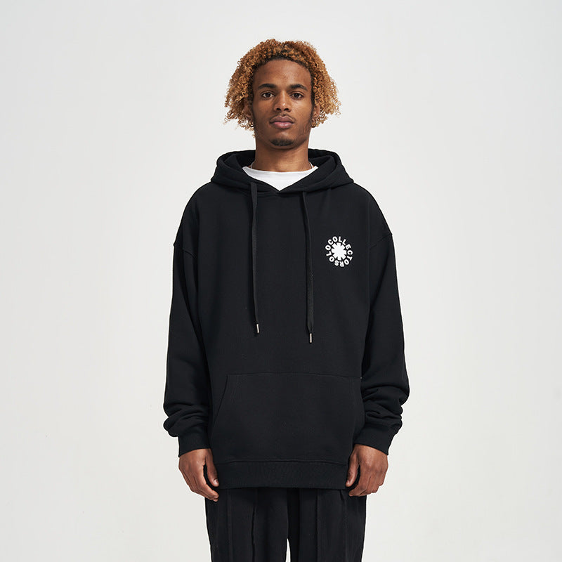 Person wearing a black hoodie with a white logo on a light gray background