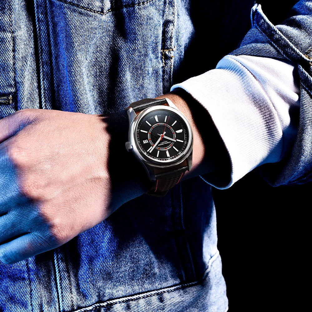 Person wearing a black wristwatch with a blue denim jacket