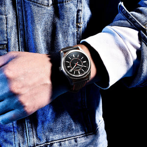 Person wearing a black wristwatch with a blue denim jacket