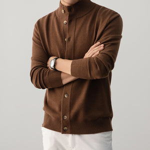 Brown button-up sweater worn by a person on a gray background