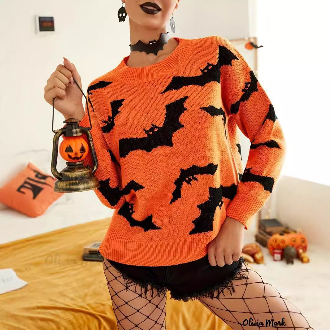 Person wearing an orange sweater with black bat patterns, holding a Halloween lantern.