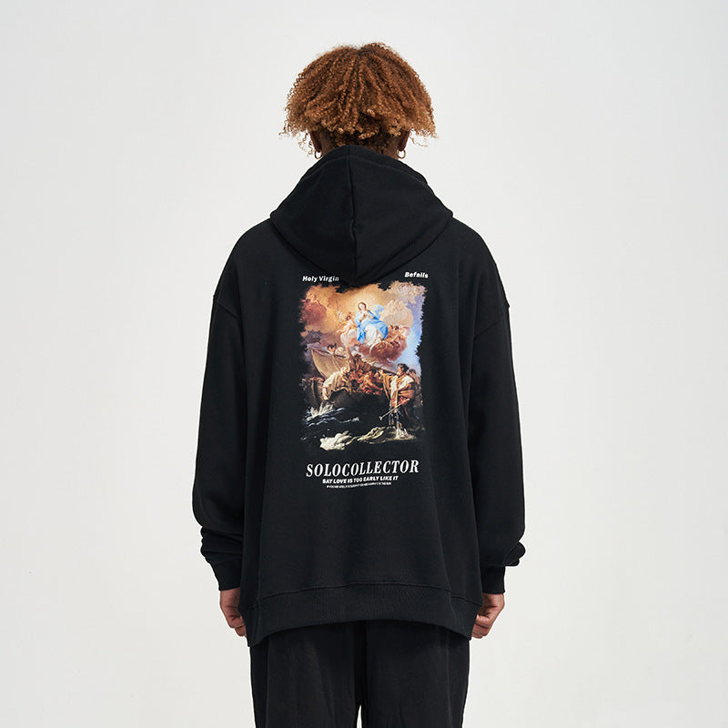 Person wearing a black hoodie with a colorful graphic and text on the back against a white background