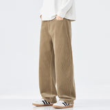 Person wearing beige corduroy pants with a white shirt on a white background