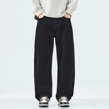 Person wearing black wide-leg pants and a light-colored sweater on a white background