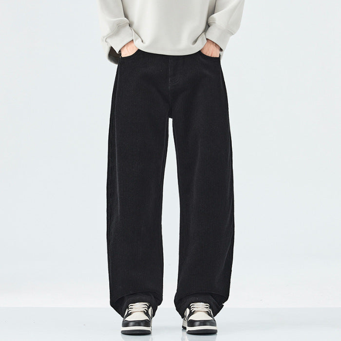 Person wearing black wide-leg pants and a light-colored sweater on a white background