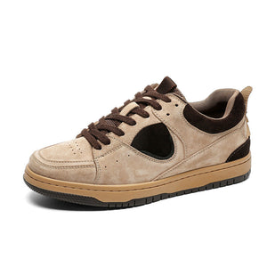 Beige sneaker with brown laces on a white background