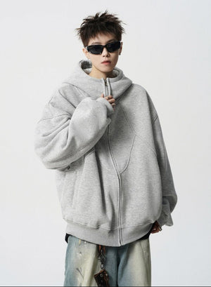 Person wearing a gray hoodie and sunglasses on a white background