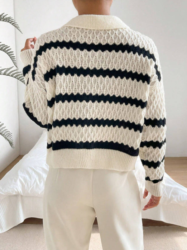 Person wearing a white and navy striped sweater with a neutral background